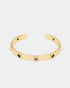 Close-up side view of gold-plated cuff bracelet showcasing colorful zircon details