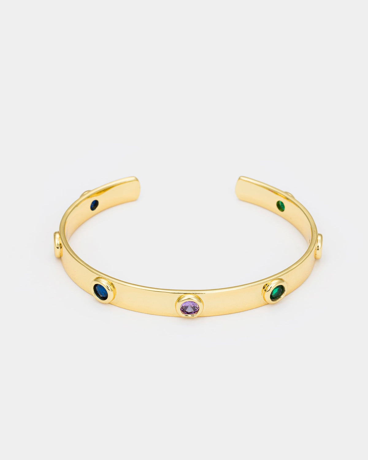 Close-up side view of gold-plated cuff bracelet showcasing colorful zircon details