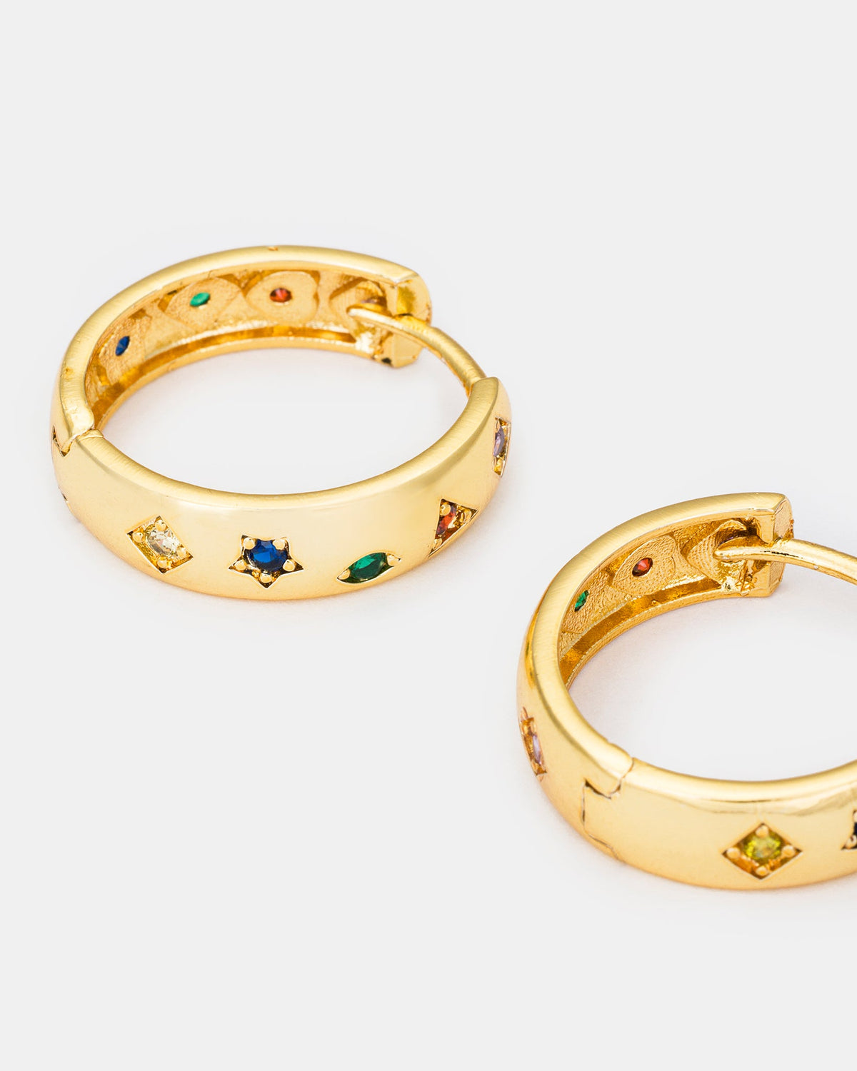 Close-up of colorful cubic zirconia gold hoop earrings