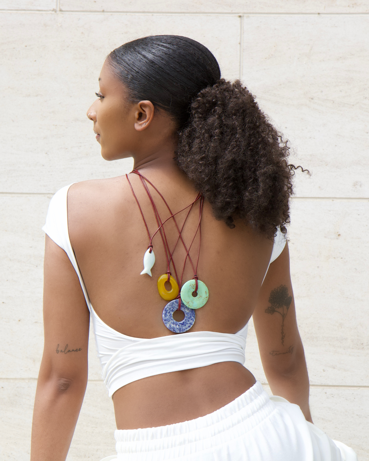 Side profile portrait wearing lapis lazuli pendant
