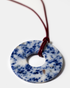 Close-up of blue lapis lazuli donut pendant