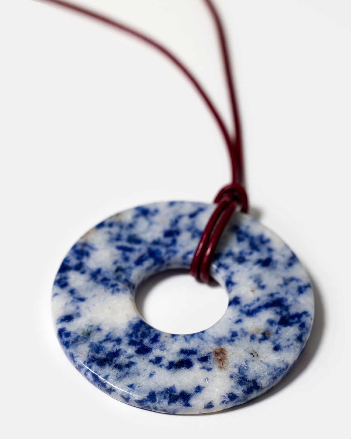 Close-up of blue lapis lazuli donut pendant