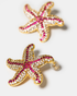 Close-up of pink starfish earrings in gold-tone finish
