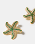Close-up of green zircon starfish earrings